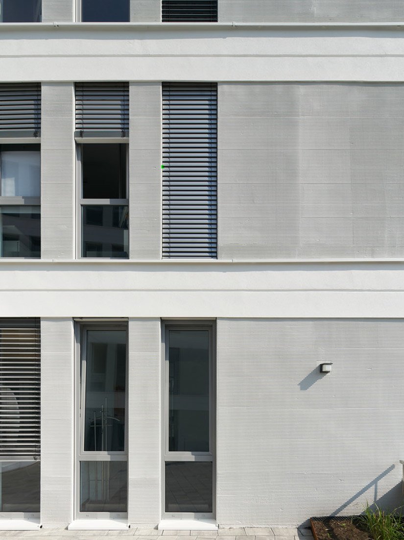 De technisch veeleisende uitvoering van de uitwendige pleisterlaag in kamtechniek en het reliëf geven het gebouw onder andere diepte en stabiliteit.