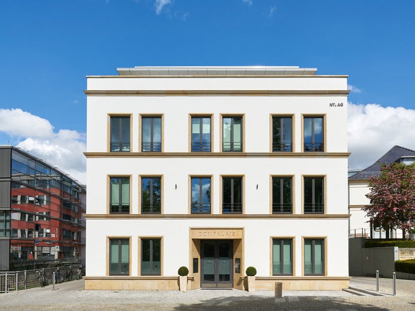Het Dompalais markeert de overgang van de historische bebouwing naar de nieuwe gebouwen en weet een fraai evenwicht te vinden tussen hoogte en een evenwichtig uiterlijk.